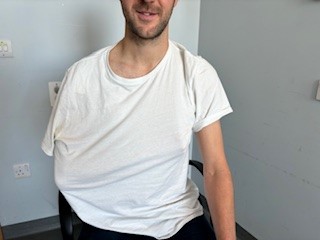 Person wearing t shirt over arm in a polysling 