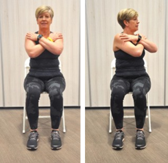 Person sitting on chair doing upper body twist exercise