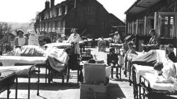 Black and white photo of Veranda of Ward A Winford with the Nurse's Home in the background & the school teacher.