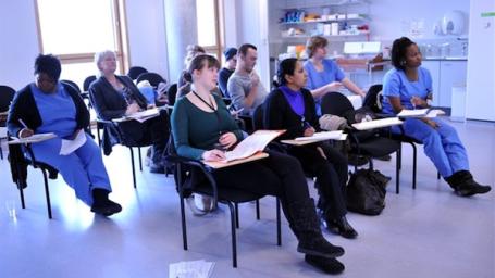 Apprentices sitting down in a classroom