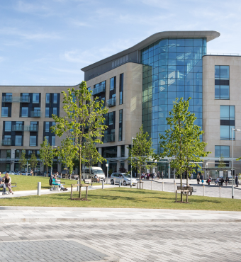 Photograph of the front of Southmead Hospital's Brunel Building on a sunny day.