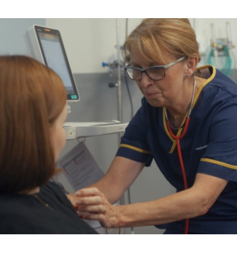 Midwife taking blood pressure